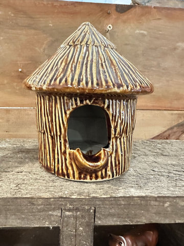 Brown pottery birdhouse