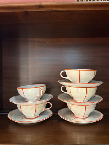 set of 5 iridescent orange and white teacups and saucers