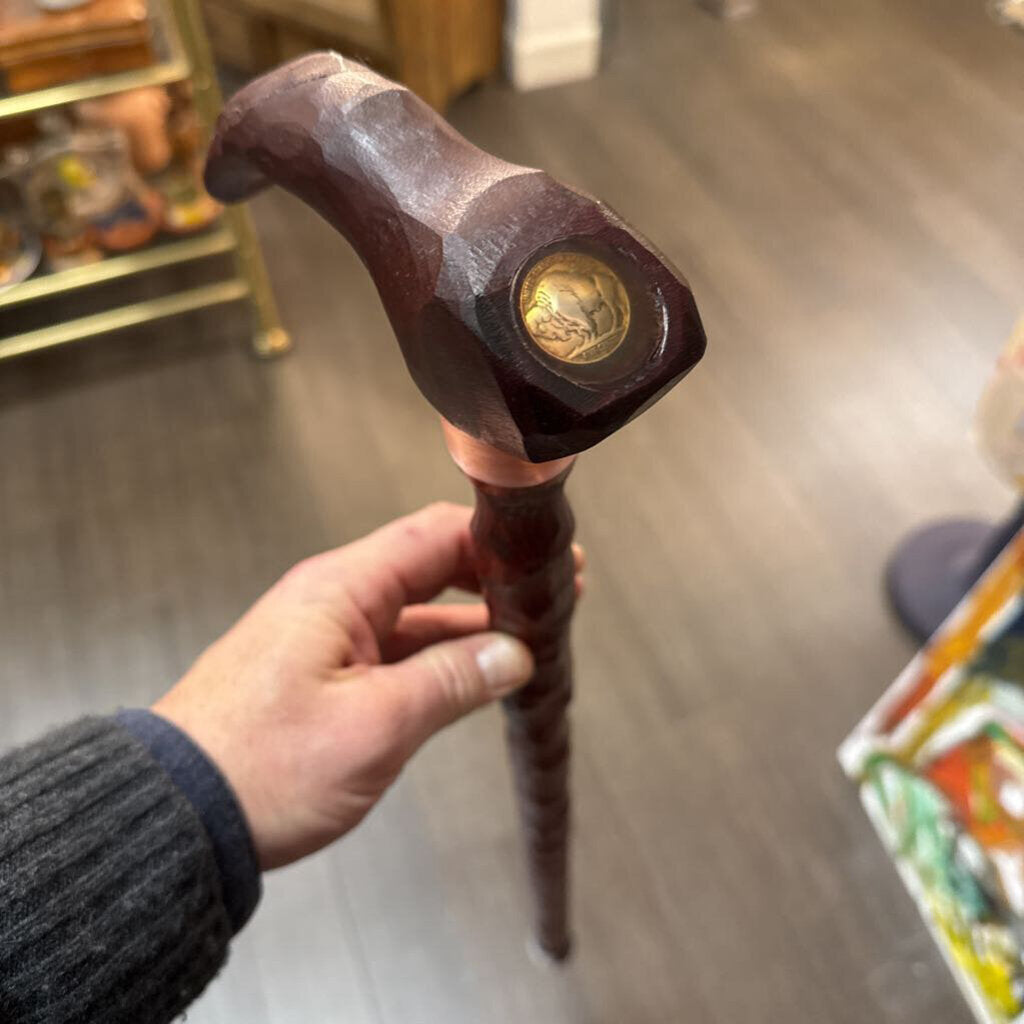 Carved wooden cane with copper wrap and buffalo nickel