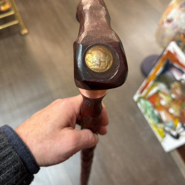 Carved wooden cane with copper wrap and buffalo nickel
